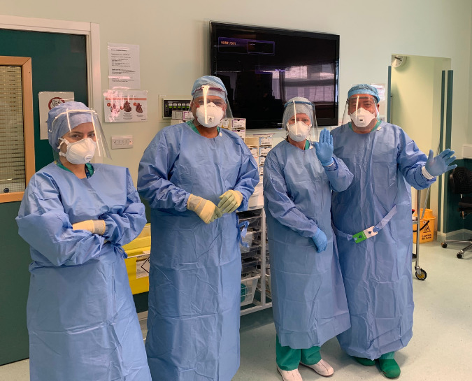 NHS Staff stood together wearing PPE