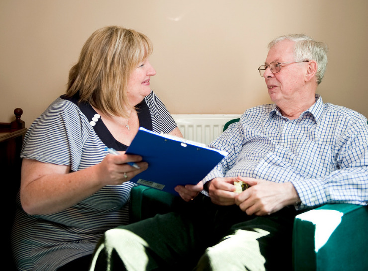 Community healthcare worker talking to a patient in their home