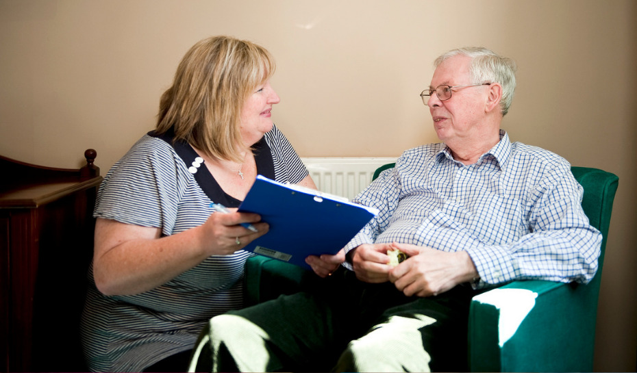 Community healthcare worker talking to a patient in their home