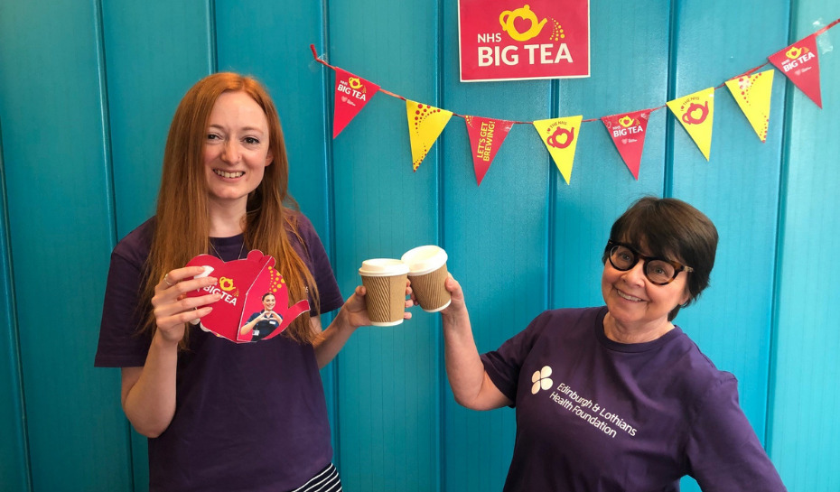 Two NHS Lothian Charity team members clinking mugs for the NHS Big Tea