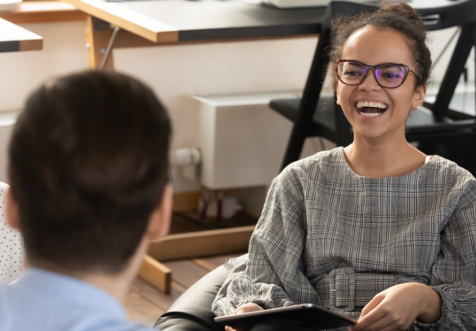 Woman laughing with colleagues 