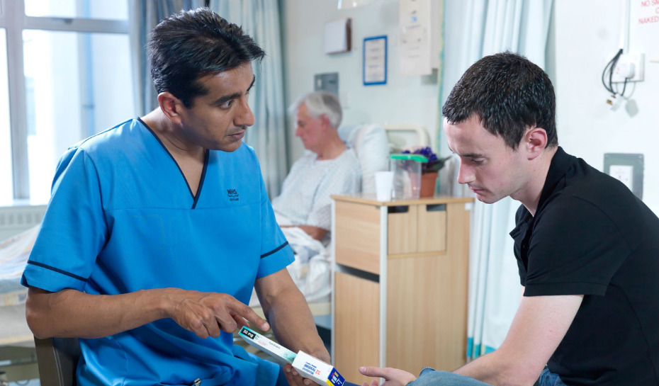 nurse explaining something to a patient in hospital