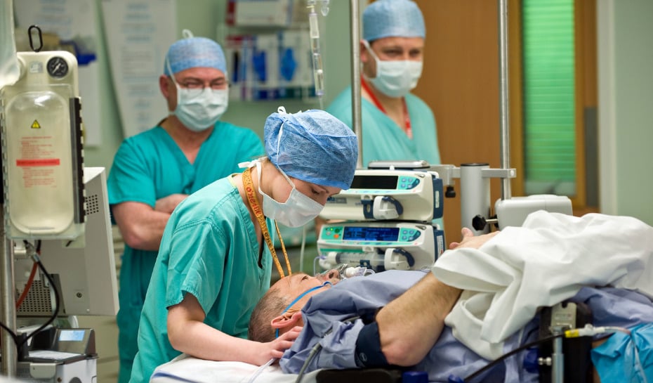 Surgery team talking to a patient in theatre