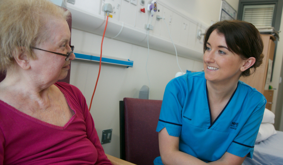 Nurse talking to a patient in hospital