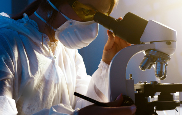 NHS staff looking through a microscope