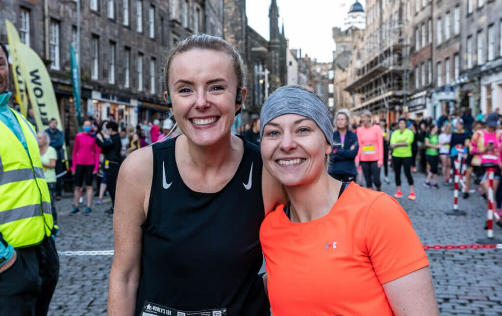 Two women runners smiling at camera