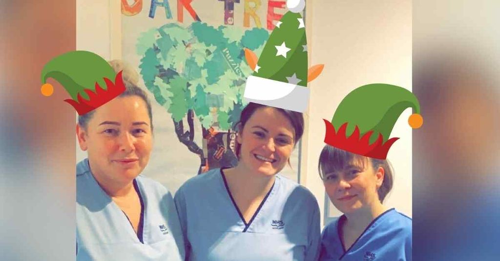 Three NHS Lothian staff smiling at the camera wearing their uniform with an elf filter putting hats on their heads