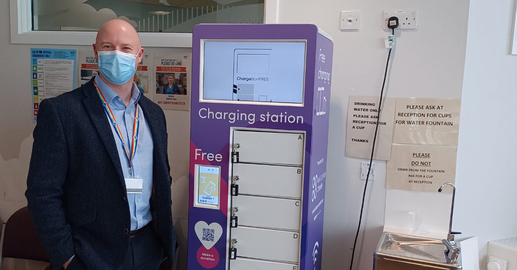 Andy Mackay, Site Director at St John's Hospital stood by the new charging point in A&E