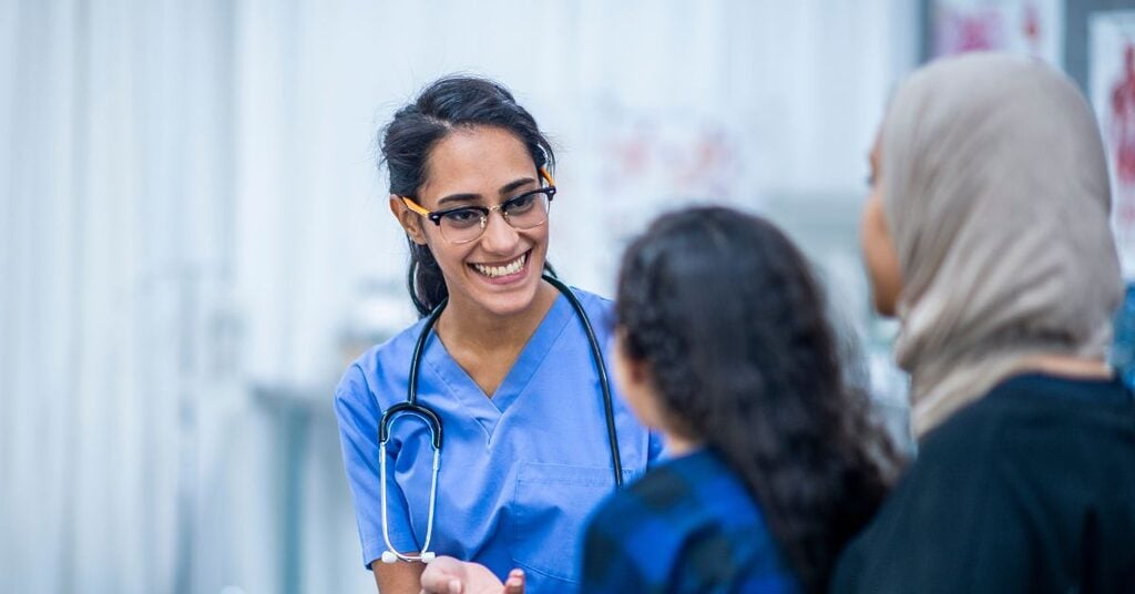 nurse talking with patient and family