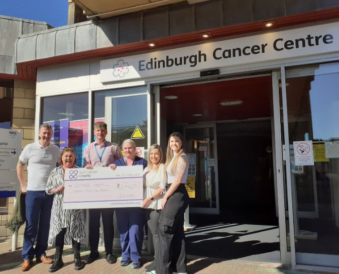 Gill Ryan and her family presenting a cheque to the Edinburgh Cancer Centre