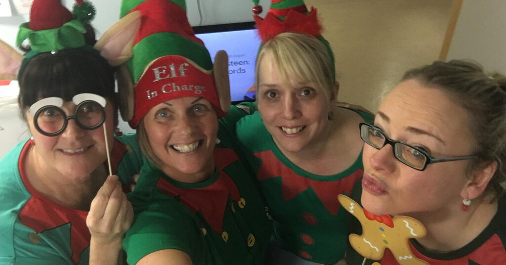 NHS staff smiling at the camera dressed as elves for the National 'Elf Service