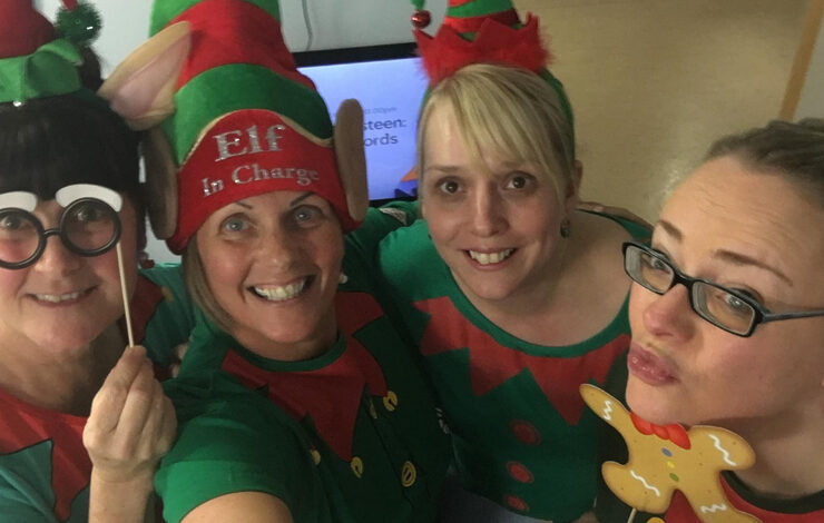 NHS staff smiling at the camera dressed as elves for the National 'Elf Service