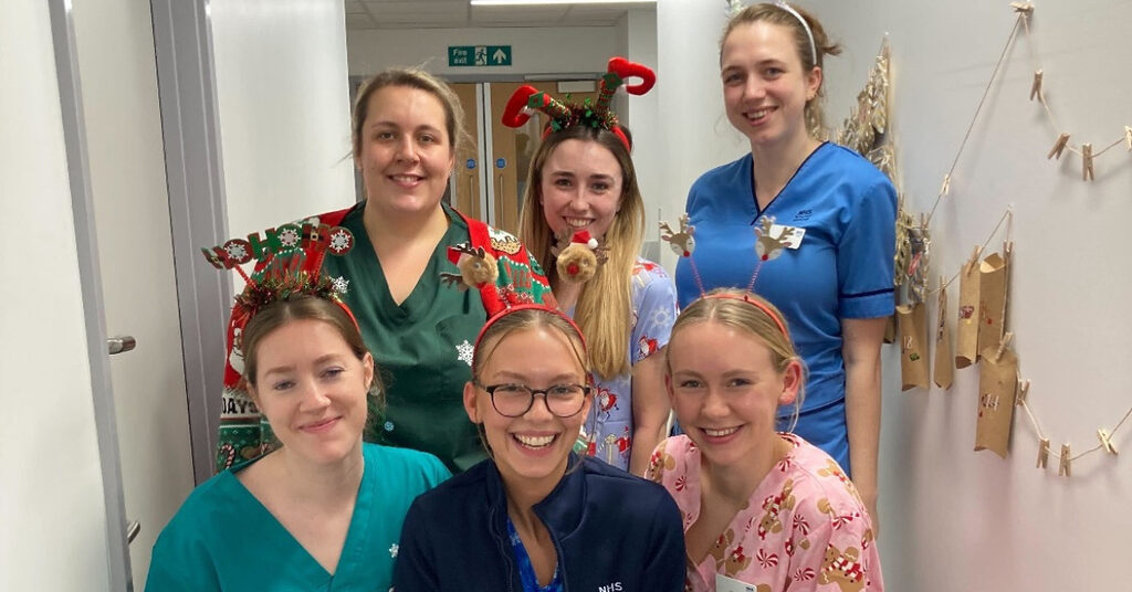 6 NHS Lothian staff on the RHCYP PCCU ward dressed up in festive outfits smiling at the camera