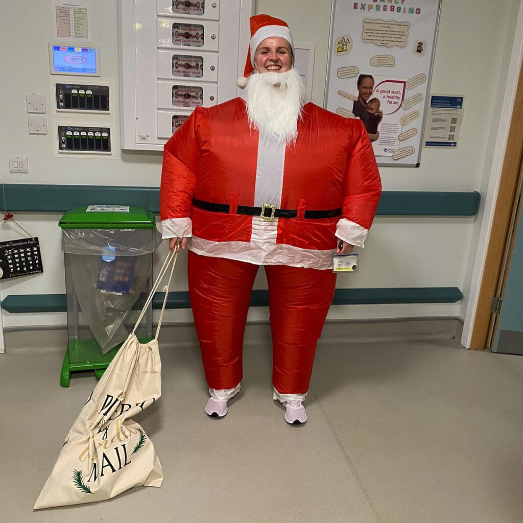 A member of staff from the Special Care Baby Unit at St Johns wearing a blow up Santa suit