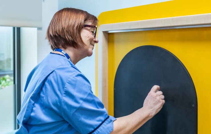 NHS Staff writing on the chalk board in the SALT Rooms at East Lothian Community Hospital