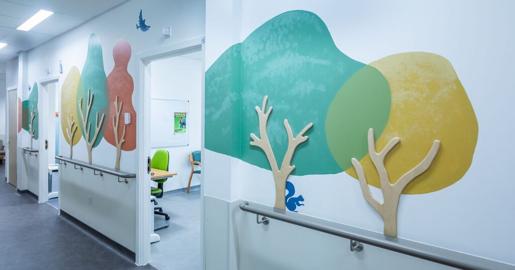 Corridor with textured trees and animals outside the SALT Rooms at East Lothian Community Hospital