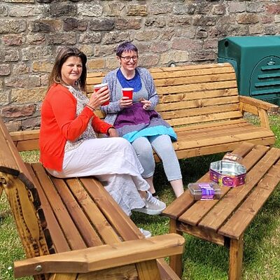 Two staff members enjoying their outdoor wellbeing space