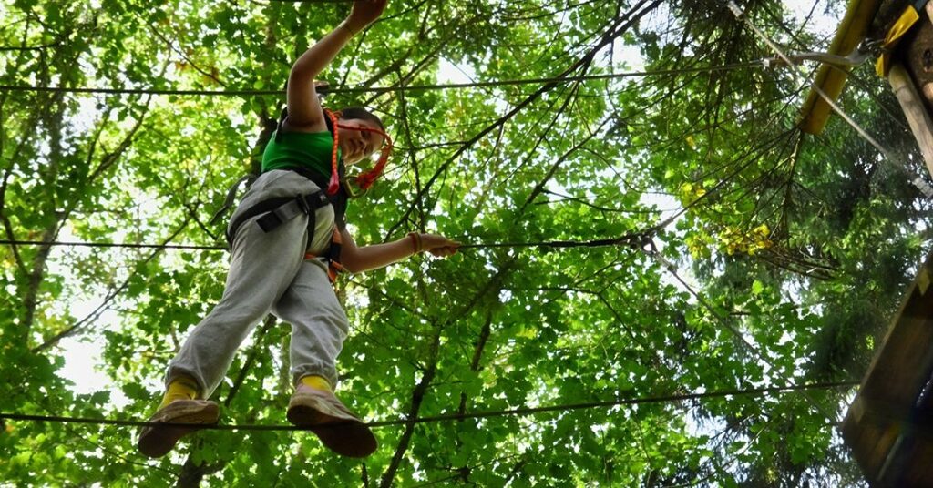 a young person on an aeriel rope course