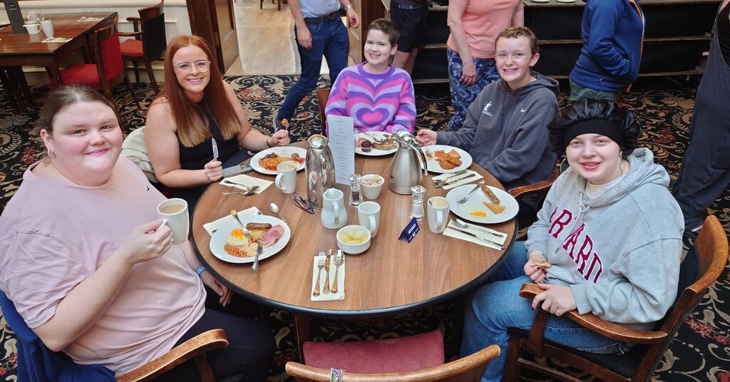 Five children sitting round a table