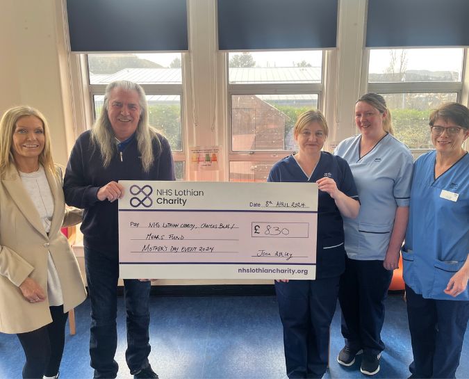 Fundraiser, Joan Ashley, handing over a cheque to the team at the Mears Ward, Astley Ainslie