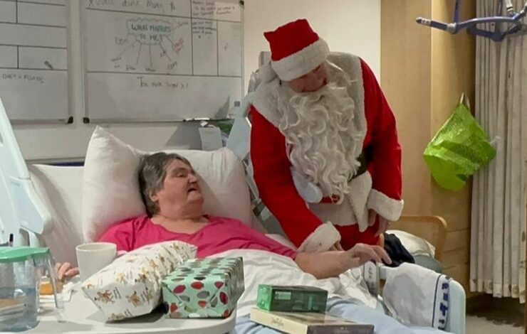 Mary, a patient in East Lothian Community Hospital getting presents from Santa while spending Christmas in hospital