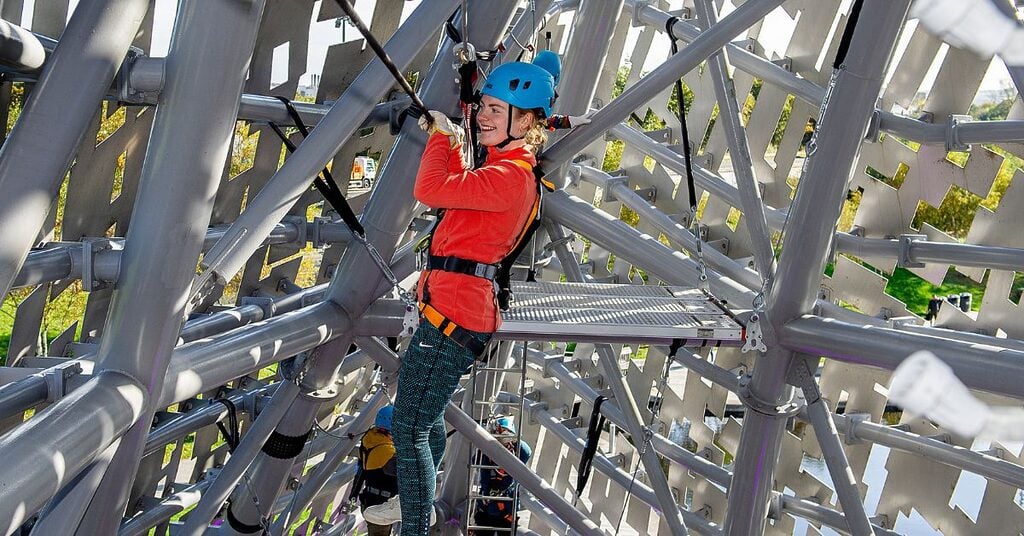 a woman on a rope bridge inside the Kelpies as part of the Kelpies Experience