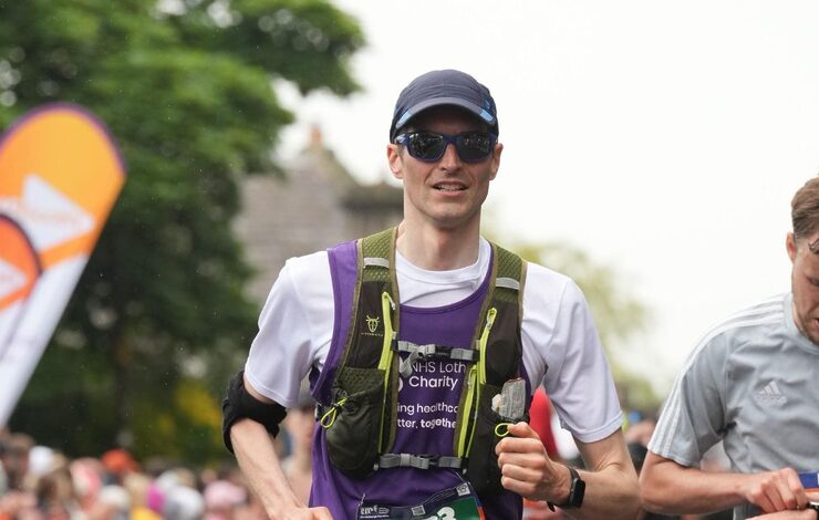 EMF runner, Neil, running past the crowds