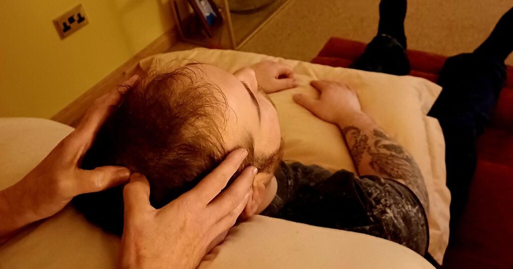a person receiving a head massage