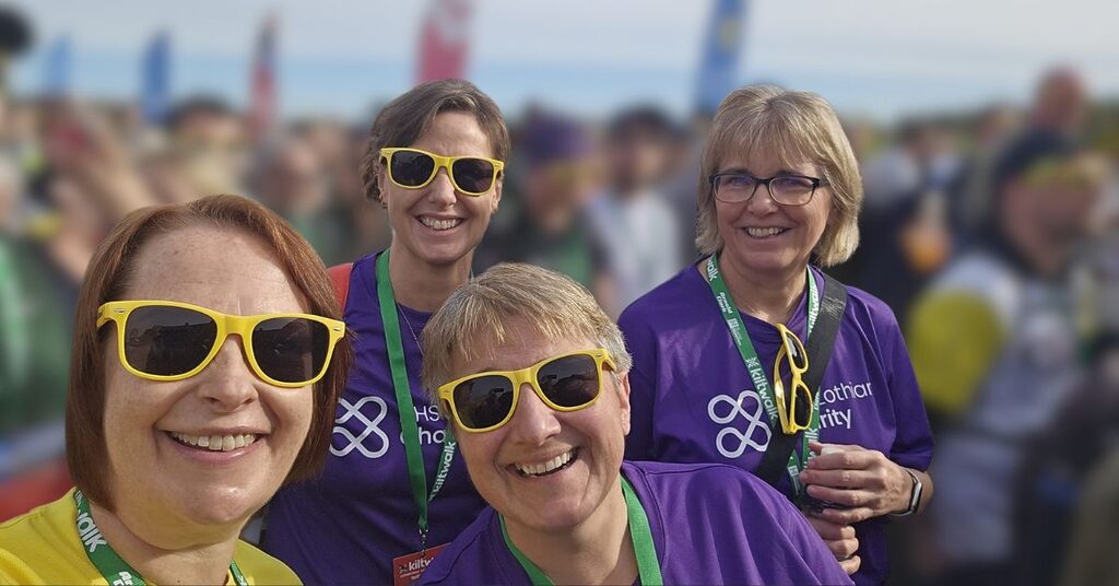 four NHS Lothian Charity champions smiling at the camera at the Kiltwalk