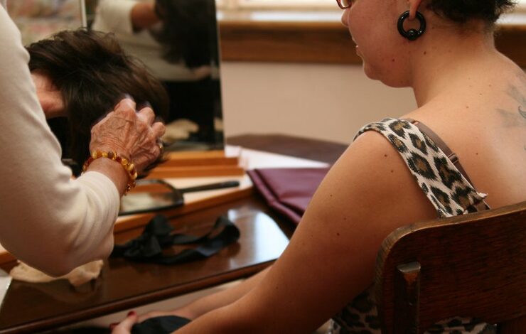a person getting a wig fitting