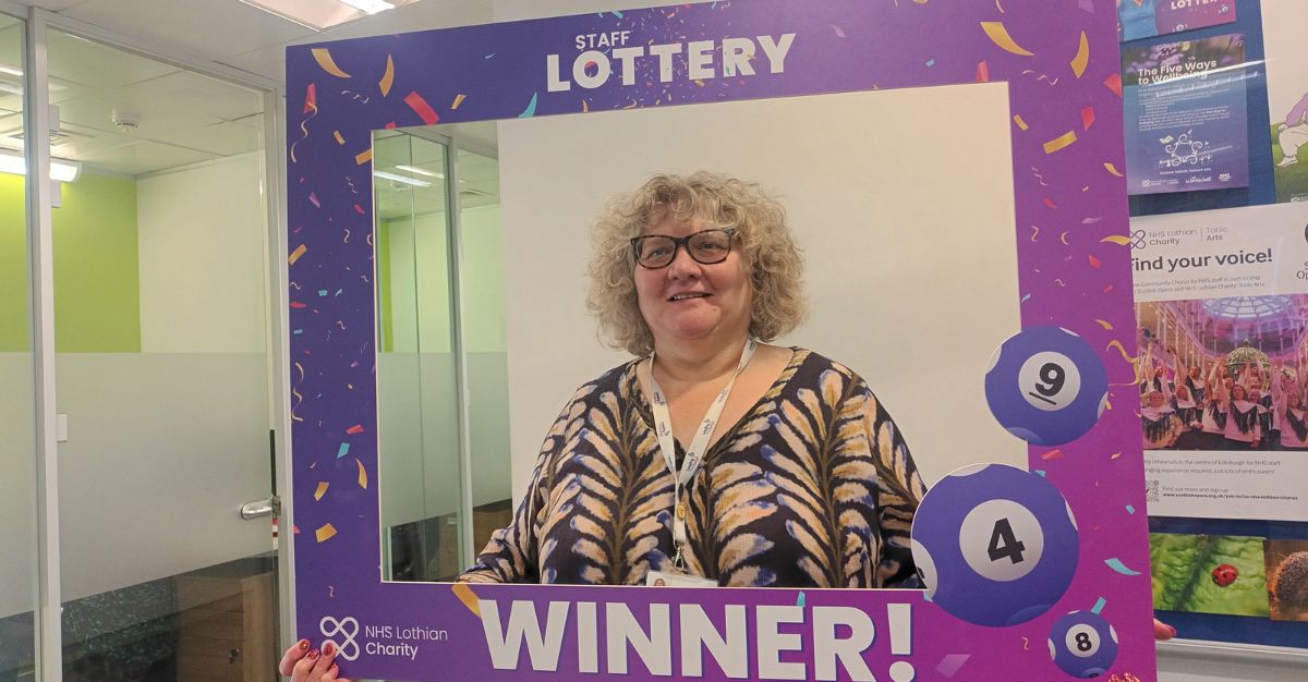 Audrey staff lottery winner with frame