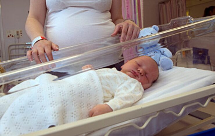 new born baby with mother looking in