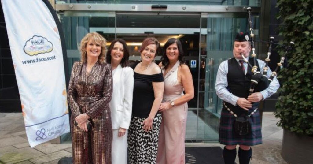 people attending the face afternoon tea standing in front of the venue with a piper