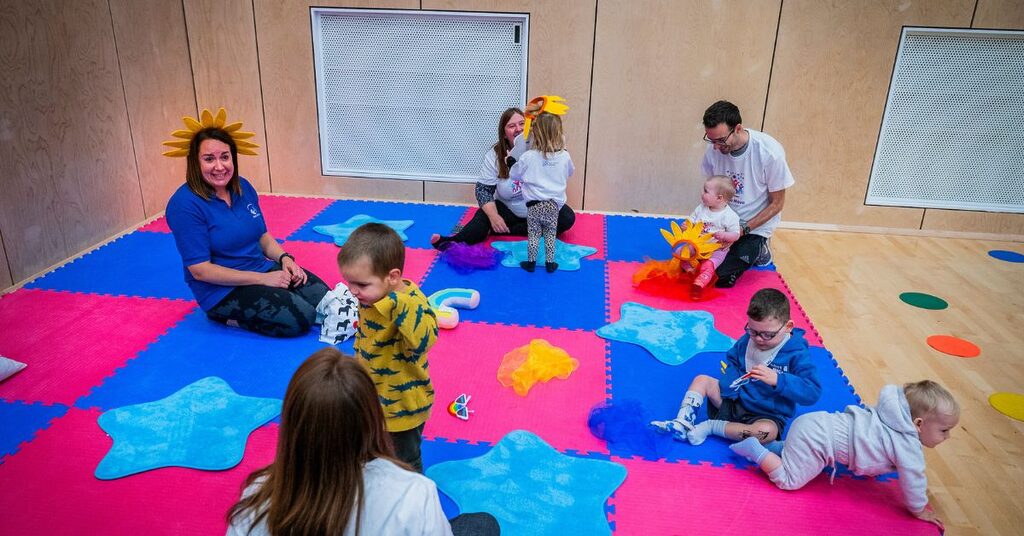 organisers, patients and families congregating on a foam floor