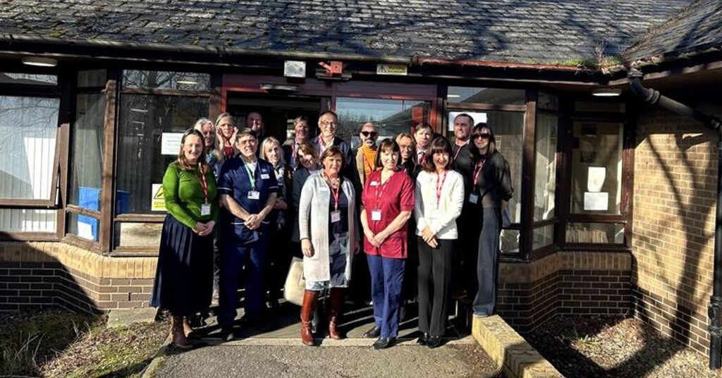 A group of staff standing at the front door of Penicuik Medical Centre