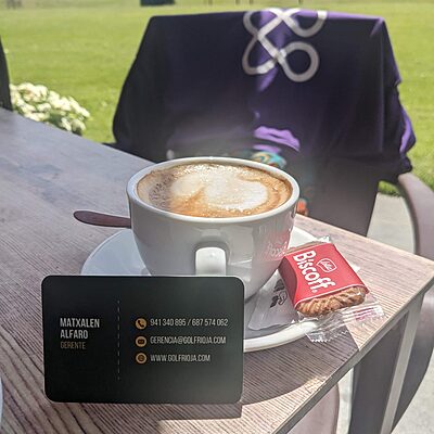 An NHS Lothian Charity t-shirt over a chair with a coffee in front of it