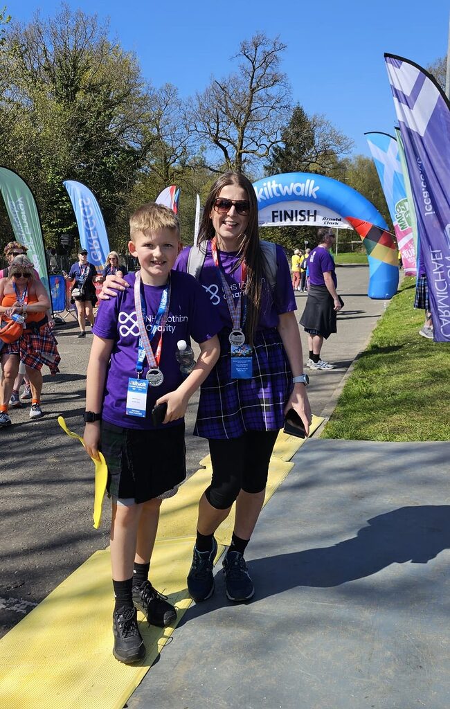 Kelsey and Jack at the Kiltwalk finish line in their NHS Lothian Charity t-shirts