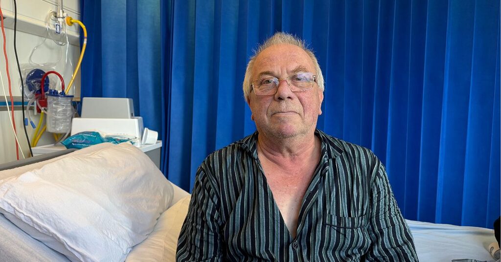 a patient sitting in a hospital bed facing the camera
