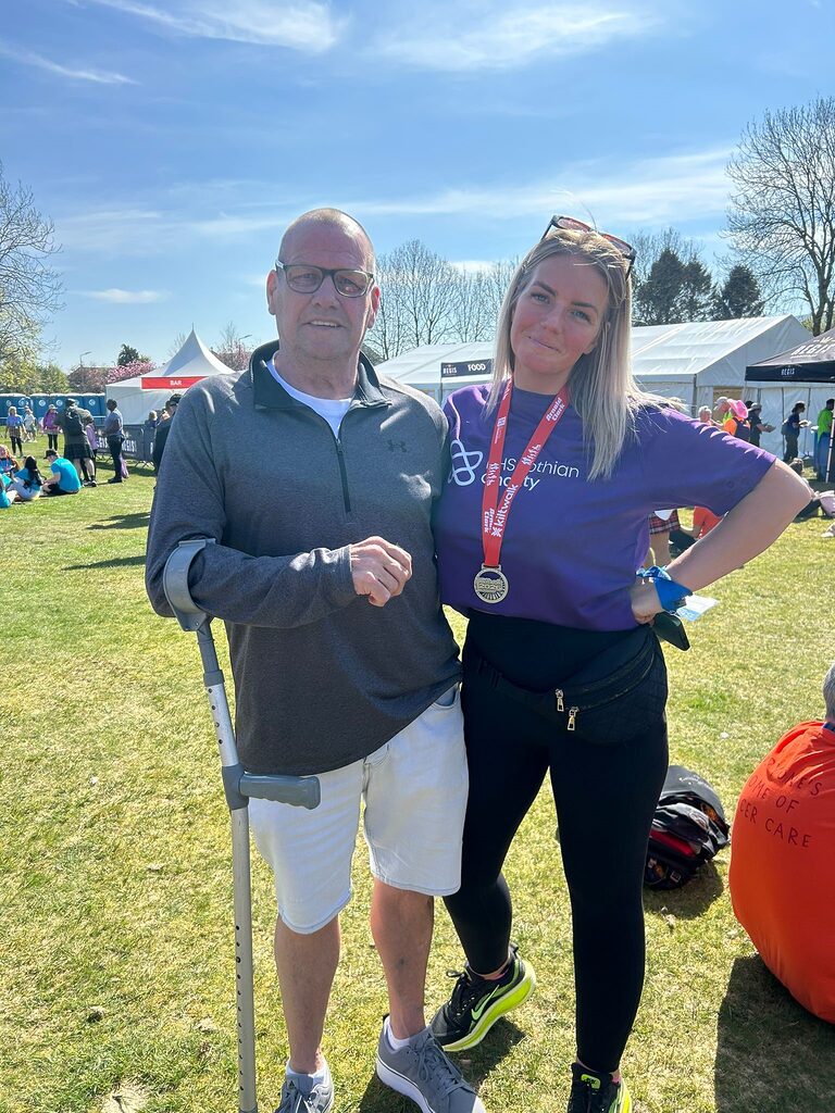 Carly and her dad at the end of the Kiltwalk in Glasgow