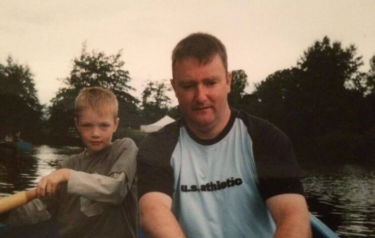 Alexander Ferguson and his dad in a boat