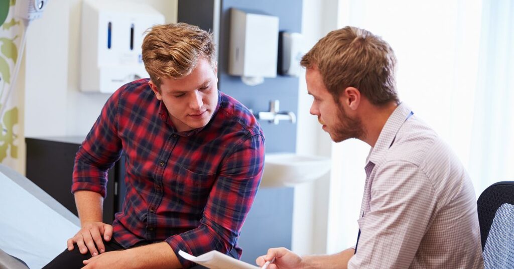 two people talking at a hospital bed
