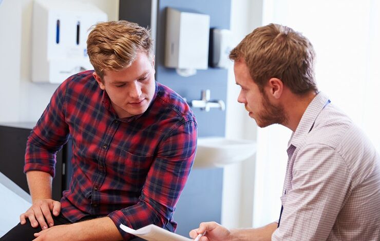 two people talking at a hospital bed