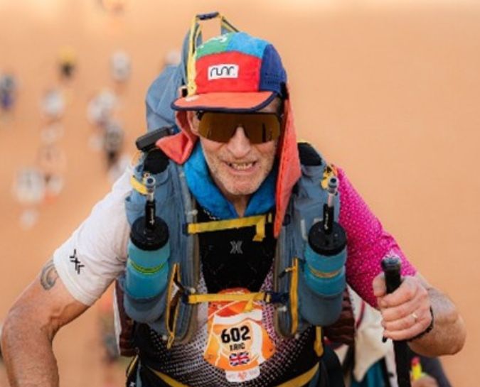 A close up of Eric with his hat and rucksack