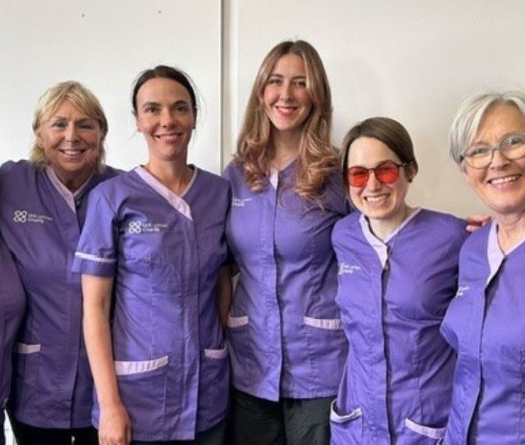 Complementary therapists in branded NHS Lothian Charity tunics smiling at the camera