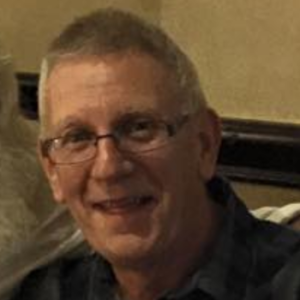 a close up of John Macauley smiling at the camera