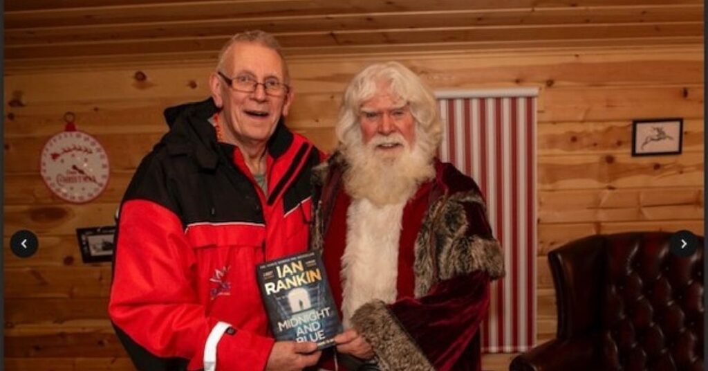 FACE volunteer John Macauley standing beside Santa Claus