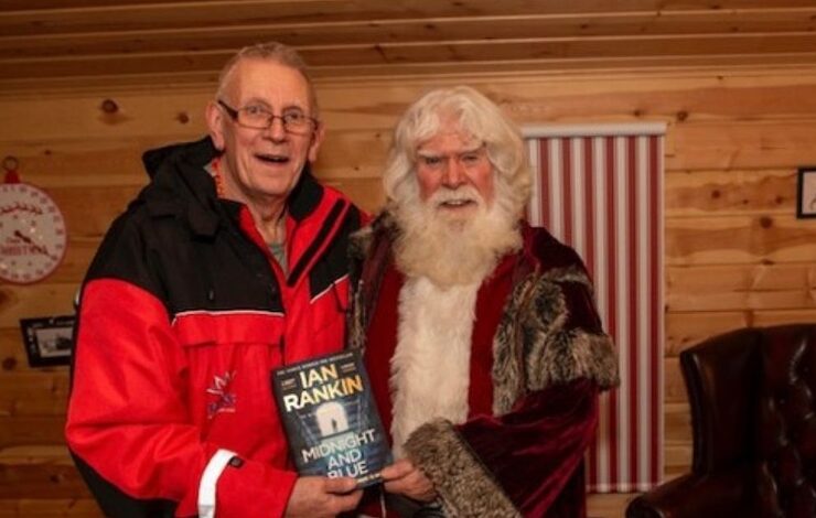 FACE volunteer John Macauley standing beside Santa Claus