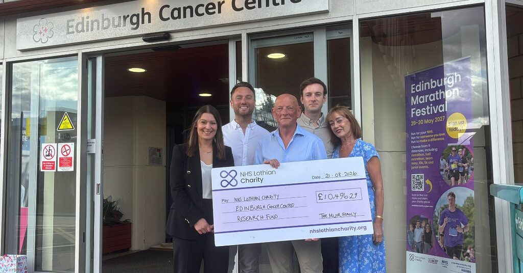 The Muir Family presenting their cheque to Rachel outside the Edinburgh Cancer Centre