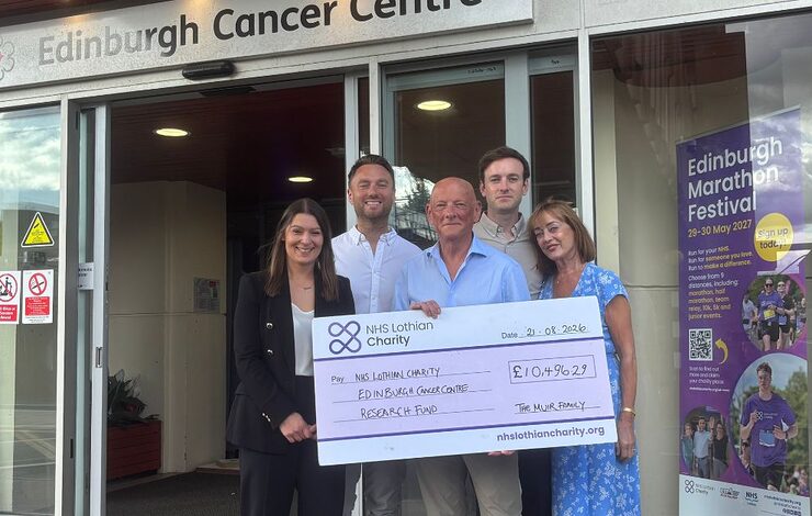 The Muir Family presenting their cheque to Rachel outside the Edinburgh Cancer Centre