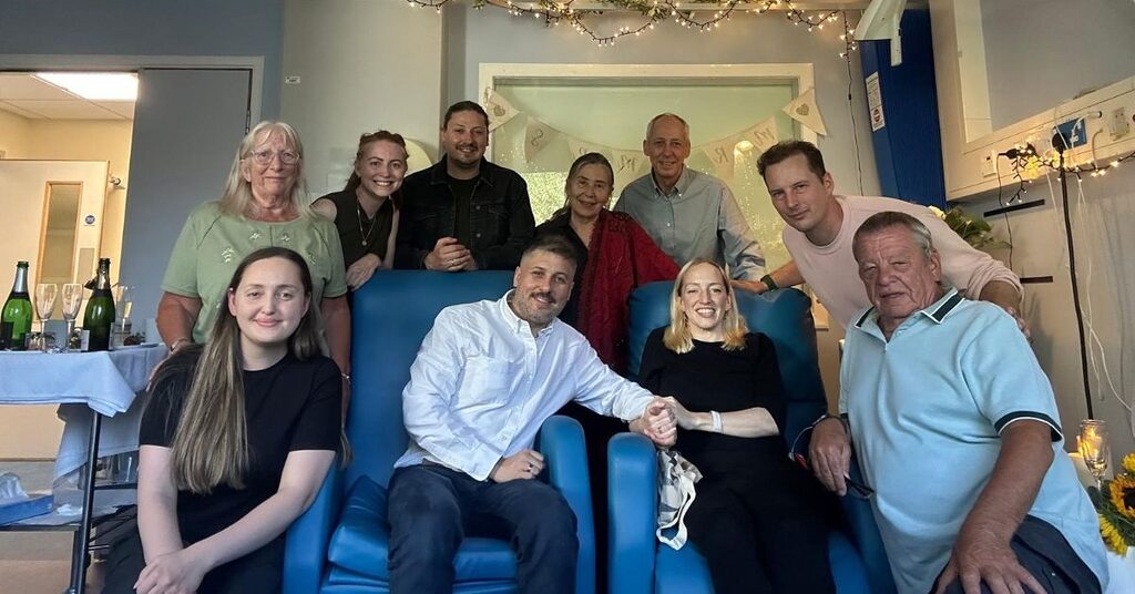 Babs and Nik with their friends and family at their wedding in the Edinburgh Cancer Centre